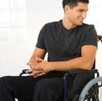 disabled man in wheelchair smiling that he has adequate income protection insurance explained