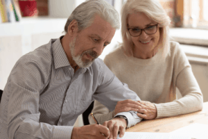 couple signing will with testamentary trust giving asset protection using estate planning