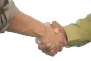 planning business succession arrangements confirmed in a handshake between an adviser and a businessperson