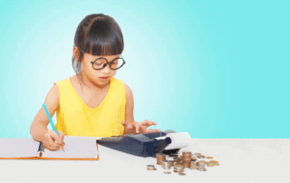 young girl in yellow dress counting coins and adding on calculator before recording in ledger, practising good financial habits
