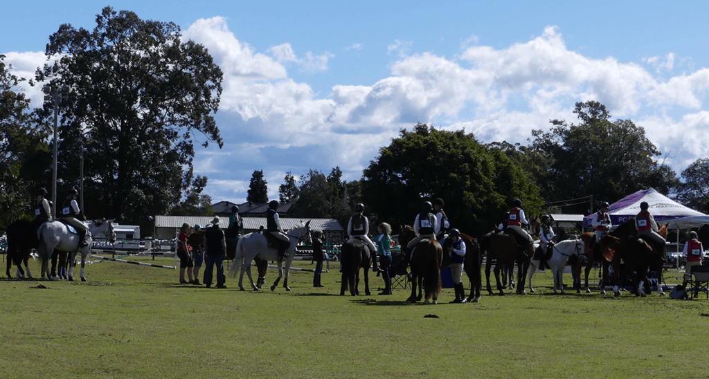 riders await entry to competition arena as parents watch on and ponder the household budget tested