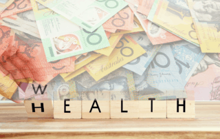 wooden blocks showing words wealth health rotating w-h block overlaid with australian paper currency notes